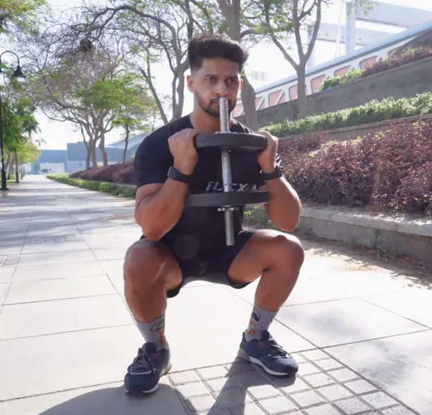 FlexAndPunch fitness trainer jasir zarkoob depicting dumbbell squats for weightloss