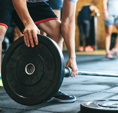 FlexAndPunch clpoaseup of a person holding barbell 