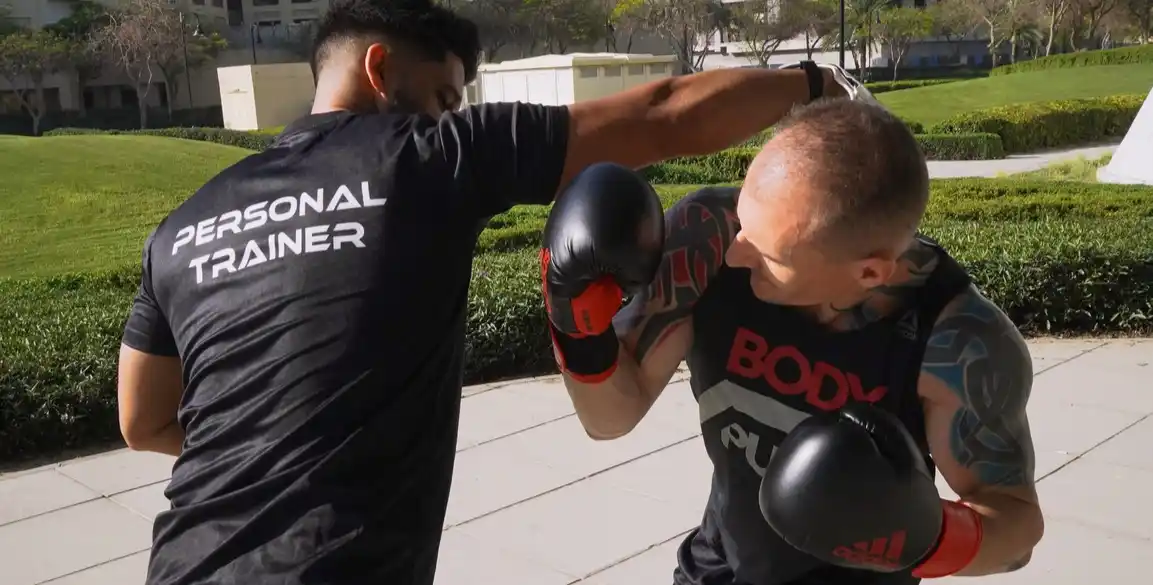 A closeup of FlexAndPunch fitness trainers displaying boxing jabs and defence