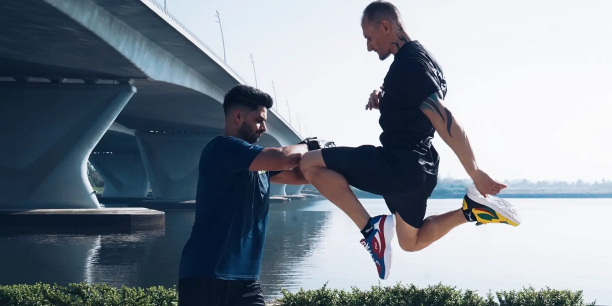 A closeup of FlexAndPunch fitness trainers displaying Muay Thai knee strike and defence