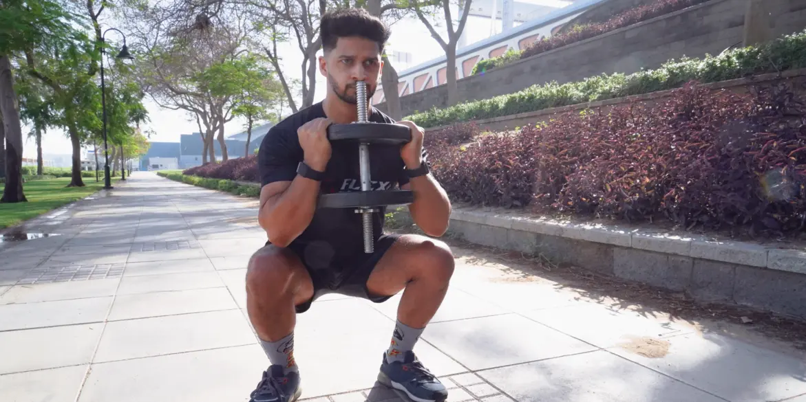 A closeup of FlexAndPunch fitness trainer jasir zarkoob depicting dumbbell squats for weightloss