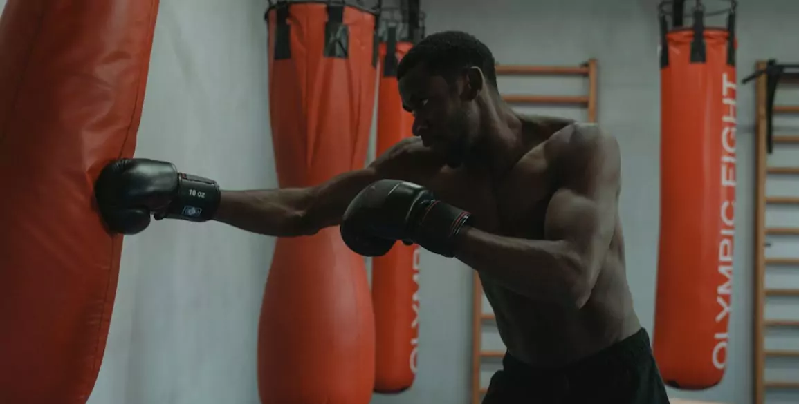 FlexAndPunch a man punching the punching bag during boxing training