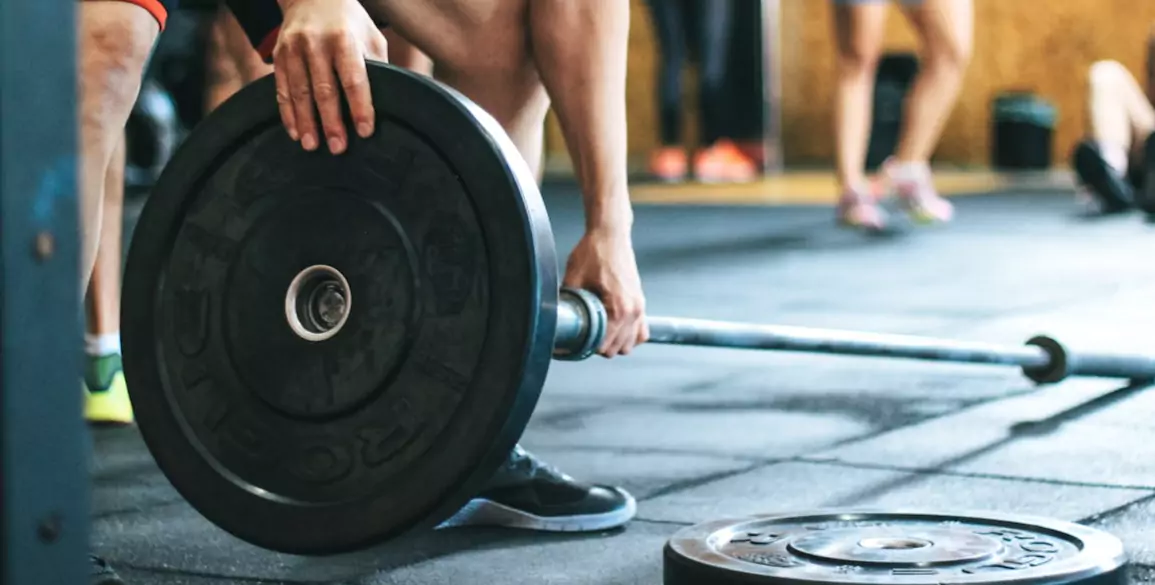 FlexAndPunch person holding barbell